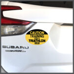 CAUTION Training For A Triathlon 140.6 Runner Decal or Car Magnet
